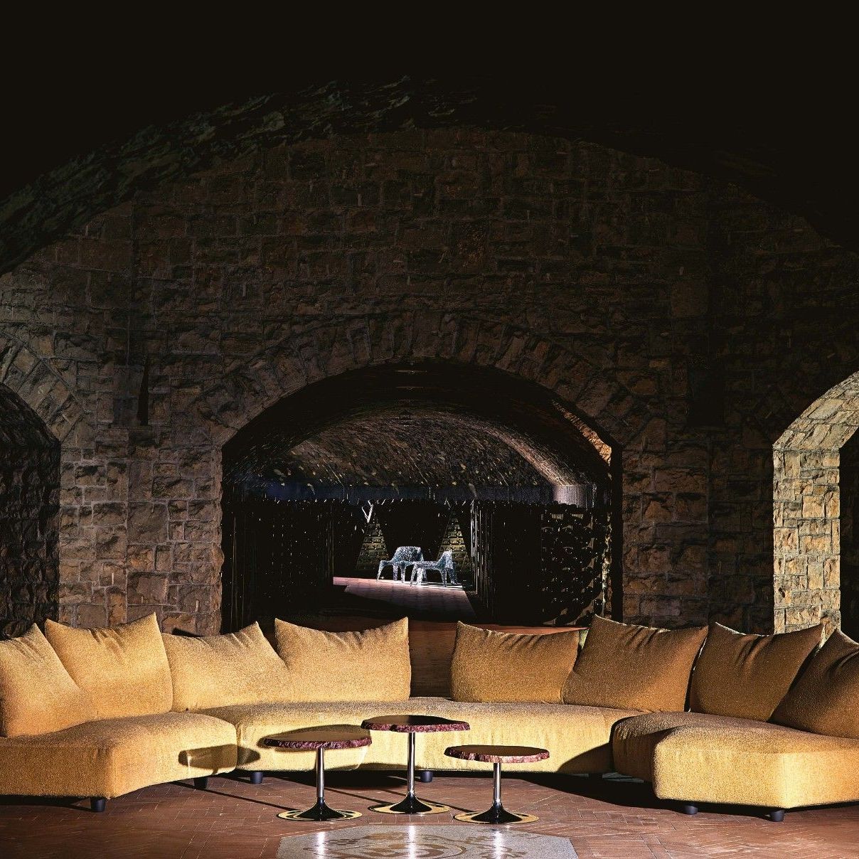  Anywhere, Cicladi, Veronica. Sofas in Minerals Light Gold and amber alabaster tables under the stone dome. Armchairs and table in the Vintage Collection gallery. 